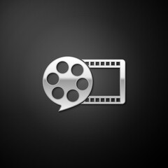 Silver Film reel and play video movie film icon isolated on black background. Long shadow style. Vector.