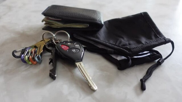 Black Mask, Keys, And A Wallet On Marble Counter, No Persons