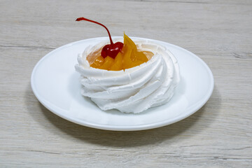 Cake in a white saucer. Cake in a saucer on a bleached wood table.