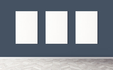 Three white empty canvases on wall. Mockup for you design preview. Good use for advertising materials.