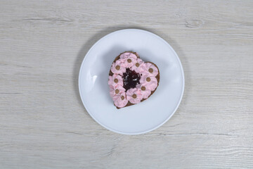 Cake in a white saucer. Cake in a saucer on a bleached wood table.