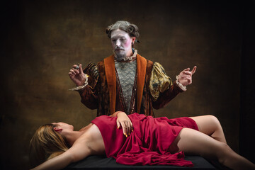 Delicious. Young man as Johann Bach isolated on dark green background. Retro style, comparison of eras concept. Beautiful male model like historical character, great music composer, old-fashioned.