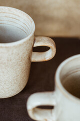 Macro abstract photography of modern minimalist ceramics set and wooden bowl.