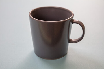 Coffee mug grey color on pastel blue background. Hot beverage cup mockup template