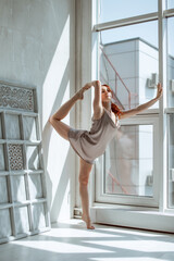 Fototapeta na wymiar Portrait of gorgeous young woman practicing yoga indoor. Beautiful girl practice in class.Calmness and relax, female happiness.