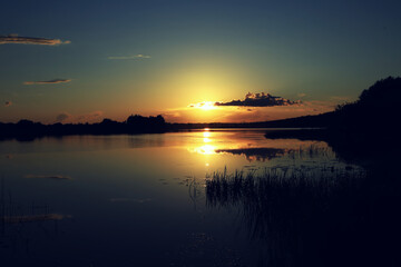 Fototapeta na wymiar Golden sunset on the lake in Russia.