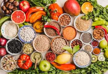 Healthy food assortment, various vegetables, fruits, legumes, grains, and superfoods concept of vegetarian diet.