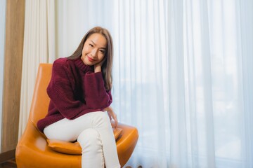Fototapeta premium Portrait beautiful young asian woman smile relax on sofa