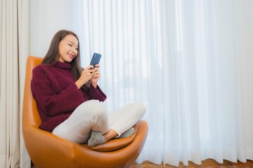 Portrait beautiful young asian woman smile relax on sofa