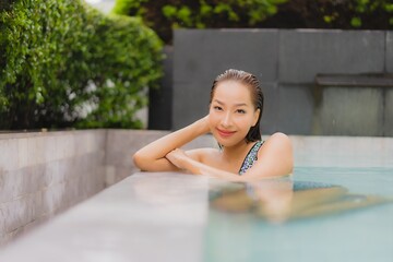 Portrait beautiful young asian woman relax smile around outdoor swimming pool