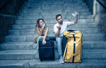Tourist couple with protective face mask worried about new travel restrictions and quarantine