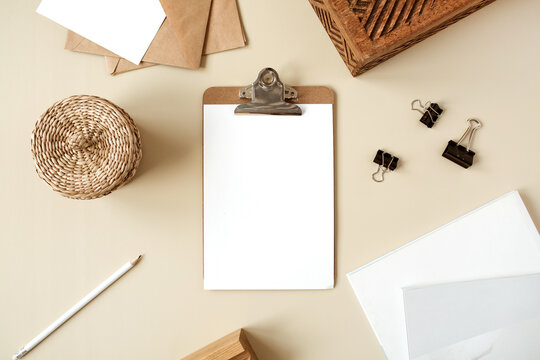 Clipboard tablet pad with blank paper sheet. Artist home office desk workspace. Flat lay, top view mockup copy space