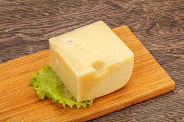 Emmental cheese over wooden board