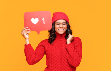 Ethnic female making wish in social media.