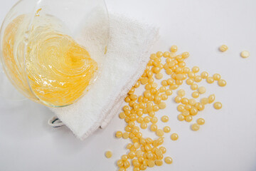 The composition of the sugaring paste, granules, white towel and twig. Flat lay with copy space on...