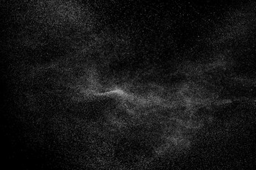 Abstract splashes of water on black background. Freeze motion of white particles. Rain, snow overlay texture.