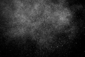 Obraz premium Abstract splashes of water on black background. Freeze motion of white particles. Rain, snow overlay texture.