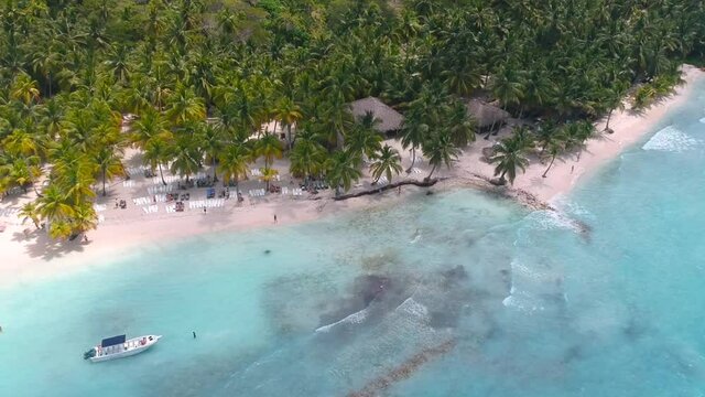 Drone shot lowering down, shot in Saona Island (Dominican Republic)  In a sunny day hitting the blue waters of the caribbean