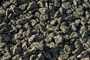 Drainage systems from small pebbles. Garden drainage for plants and trees. Black stones for roads and flower beds.
