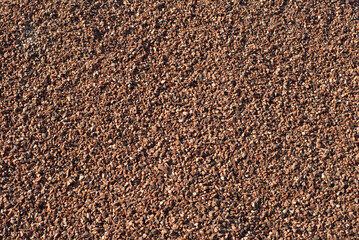 Drainage systems from small pebbles. Garden drainage for plants and trees. Red stones for roads and flower beds.