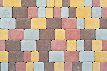 Cobblestone texture. The sidewalk tile is evenly folded. Brown and orange cobblestones close up.