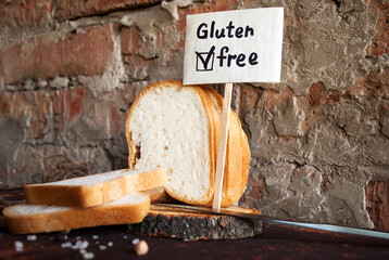Gluten-free sliced bread on a red brick wall background. Gluten-free sign.
