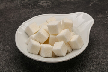 Refined white sugar cubs in the bowl