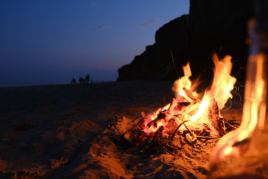 Campfire on the Empty Beach with Girl Silhouette Background