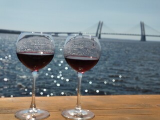 Glass of wine on the background of the bridge in St. Petersburg, Russia