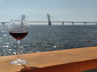 Glass of wine on the background of the bridge in St. Petersburg, Russia