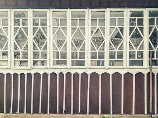 Old wooden windows on the wall of a rural house