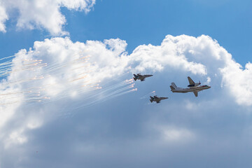 Fototapeta na wymiar Daylight. large aircraft accompanied by combat vehicles. blue sky