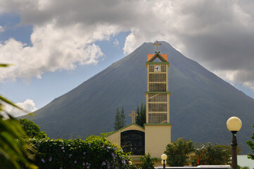 La Fortuna de San Carlos Catholic church tower with Arenal volcano Costa Rica