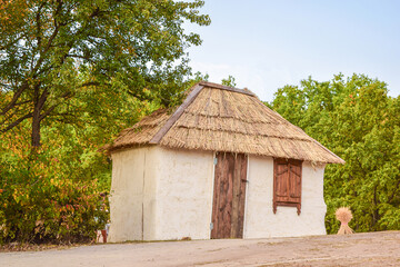 Recreated old peasant hut with a thatched roof