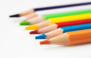 Close up of color pencils on white background.