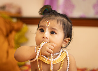 Cute baby dressed up like lord krishna/gopal in the occasion of janmashtami stock image.