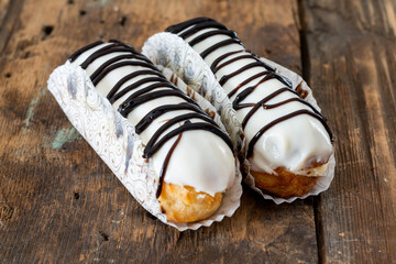 Small eclair with chocolate and cream