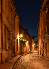 One of the charming streets of Beaune by night, France 