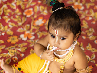 Cute baby dressed up like lord krishna/gopal in the occasion of janmashtami stock image.