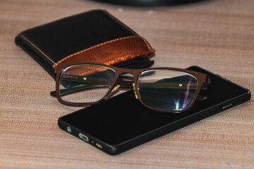 men's lifestyle accessories, wallet, cell phone and glasses for everyday use. Fashion vintage accessories