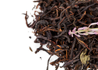 Blooming Chamerion angustifolium (common names: fireweed, great willowherb, rosebay willowherb) flower on a heap of herbal tea isolated on a white background.