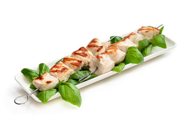 Grilled chicken breast fillet with basil on a skewers isolated on white