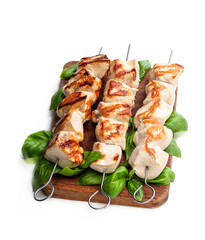 Grilled chicken breast fillet with basil on a skewers isolated on white