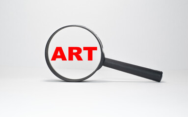 ART inscription in a magnifying glass on a boundless white background