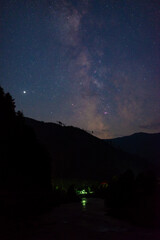 Milky Way over the mountains of the Alps in Austria. Bright star is planet Saturn.