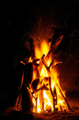Bonfire with flying sparks at night on Costa Rican beach