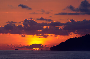Sun touches the horizon on the Pacific Ocean at Carate Costa Rica