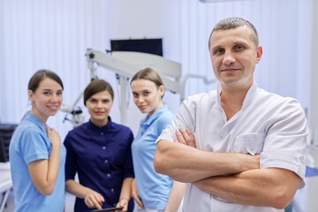 Team of colleagues dentists, portrait of doctors looking at the camera in dental office