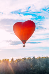 Heart-shaped hot air balloon in the sky in summer, banner