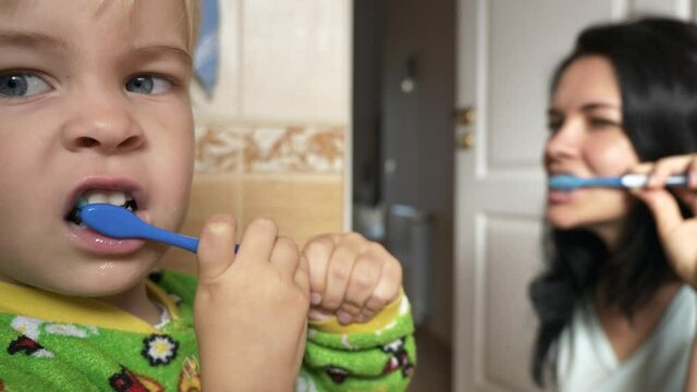 Mother and Son Brush Teeth in Bathroom in Morning After Sleep. 2x Slow motion - 60FPS